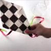 Close-up of a colourful eco-friendly kite created using plastic bag and string