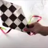 Close-up of a colourful eco-friendly kite created using plastic bag and string