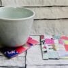 Finished recycled magazine coaster showing a colourful woven pattern