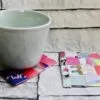 Finished recycled magazine coaster showing a colourful woven pattern